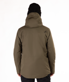 Person wearing a olive green jacket with a brand logo on the back from behind against a white background