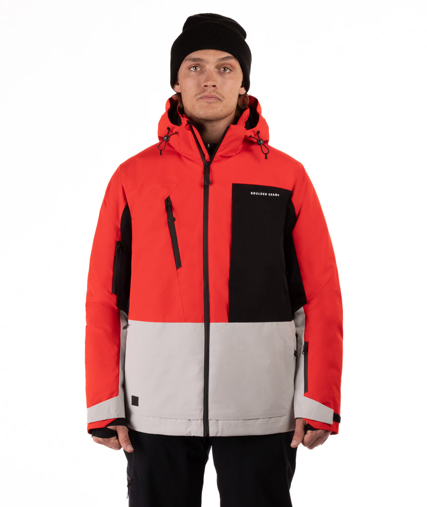 Person wearing a red, black, and gray jacket with a visible brand logo on a white background