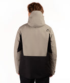 A person shown from the back wearing a colorblock hooded jacket, featuring a light taupe upper section and black lower section, against a plain white background.
