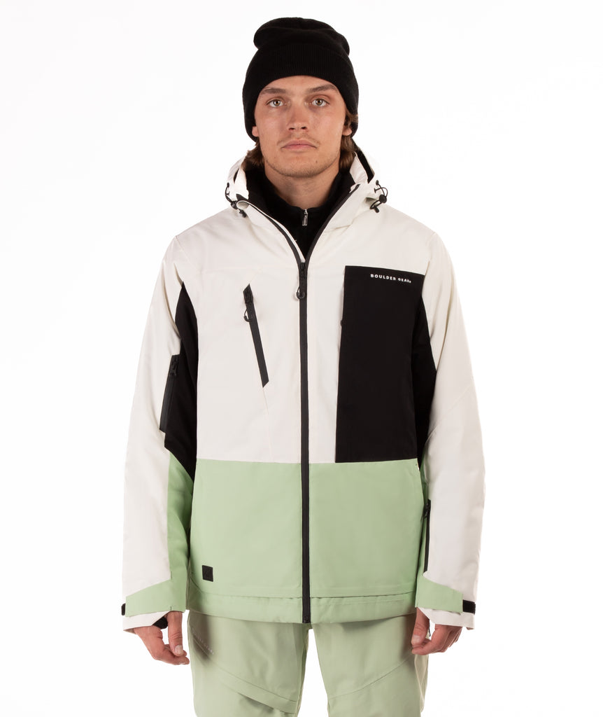 Person wearing a color-blocked jacket with white, black, and light green sections on a white background.