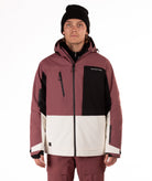 Person wearing a maroon, black, and white jacket on a white background