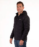 Man wearing a black jacket with a brand logo on a white background