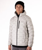 Person wearing a light gray jacket with a black zipper on a white background