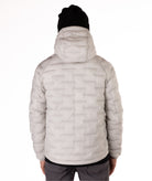 Light gray puffer jacket worn by a person on a white background