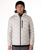 Person wearing a light gray puffer jacket with a brand logo on a white background