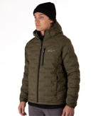 Man wearing a green puffer jacket with black zippers and a brand logo on a white background