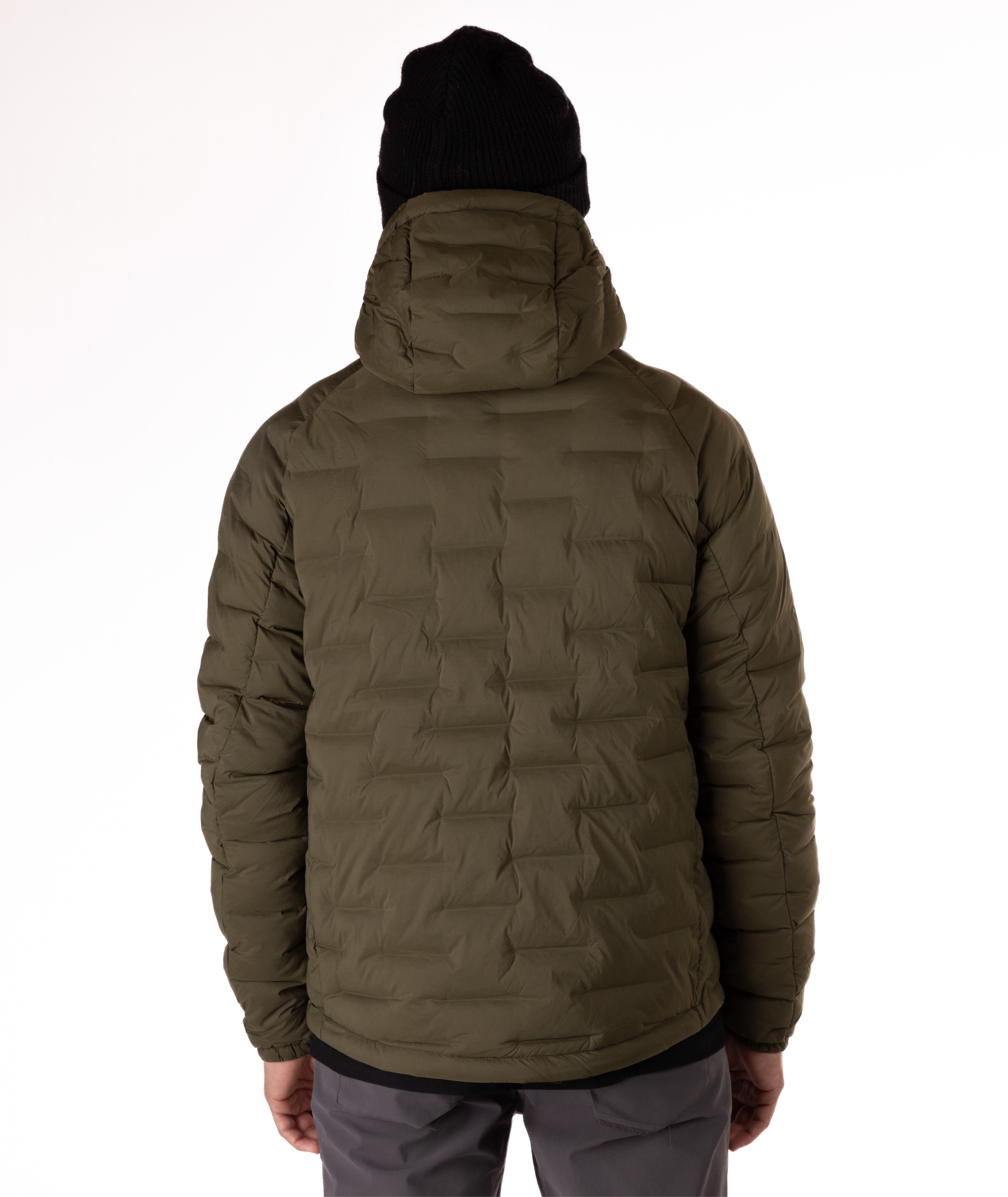 Man wearing a green puffer jacket with black zippers and a brand logo on a white background