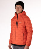Man wearing a orange puffer jacket with black zippers and a brand logo on a white background