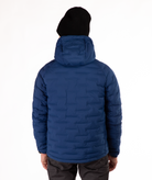 Person wearing a blue puffer jacket on a white background