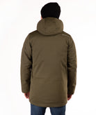 back of man wearing a green hooded jacket and black beanie on a white background