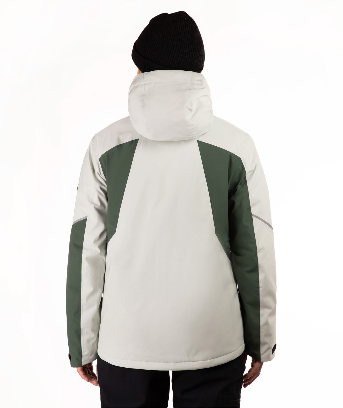 A person shown from the back wearing a hooded jacket with a light green body and dark green shoulder and sleeve panels, along with a black beanie and dark pants, against a plain white studio background.
