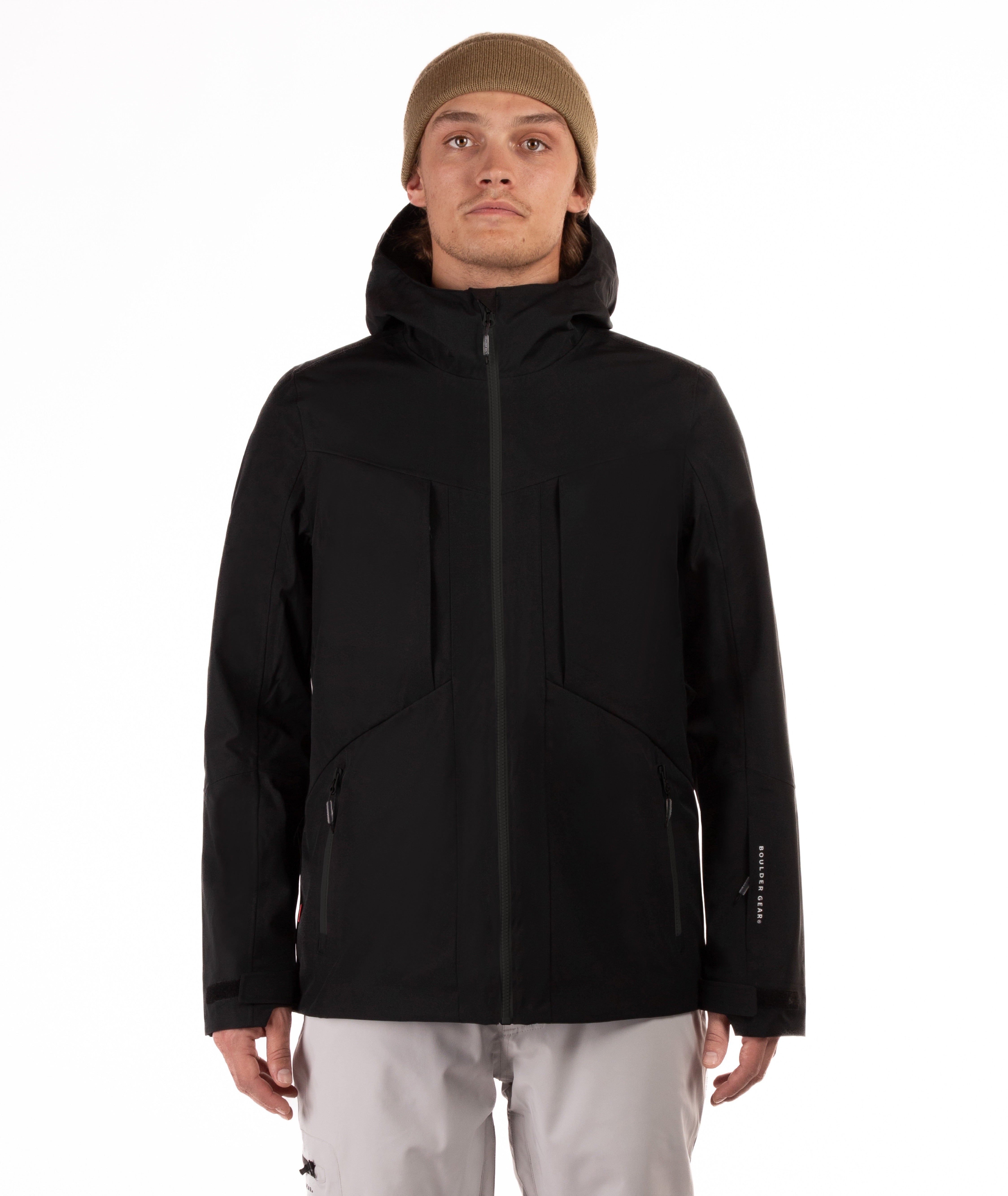 Person wearing a black jacket with black accents on a white background