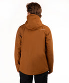 A person shown from the back wearing a brown hooded jacket and black pants against a plain white studio background.
