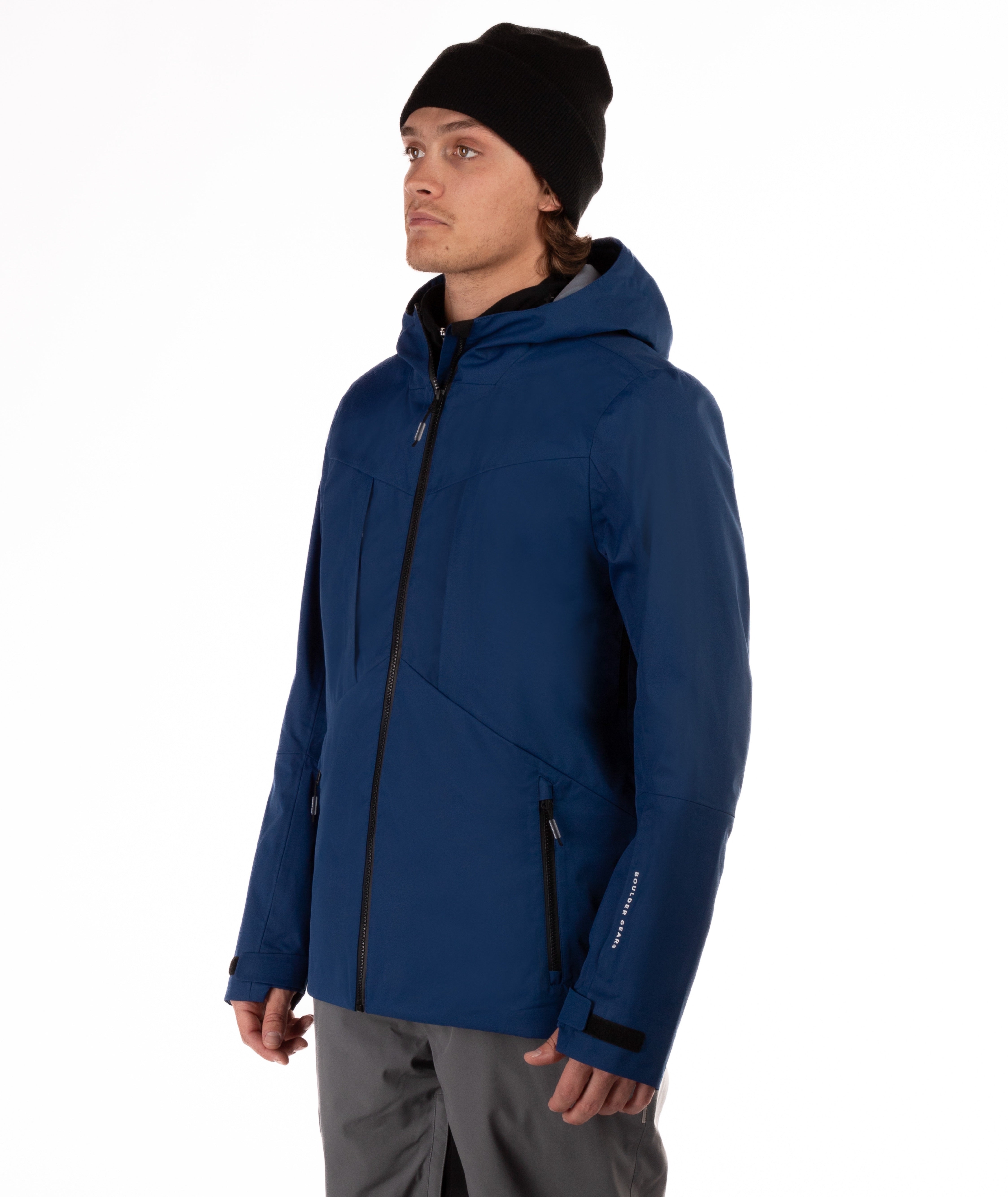 Man wearing a blue jacket with black accents on a white background