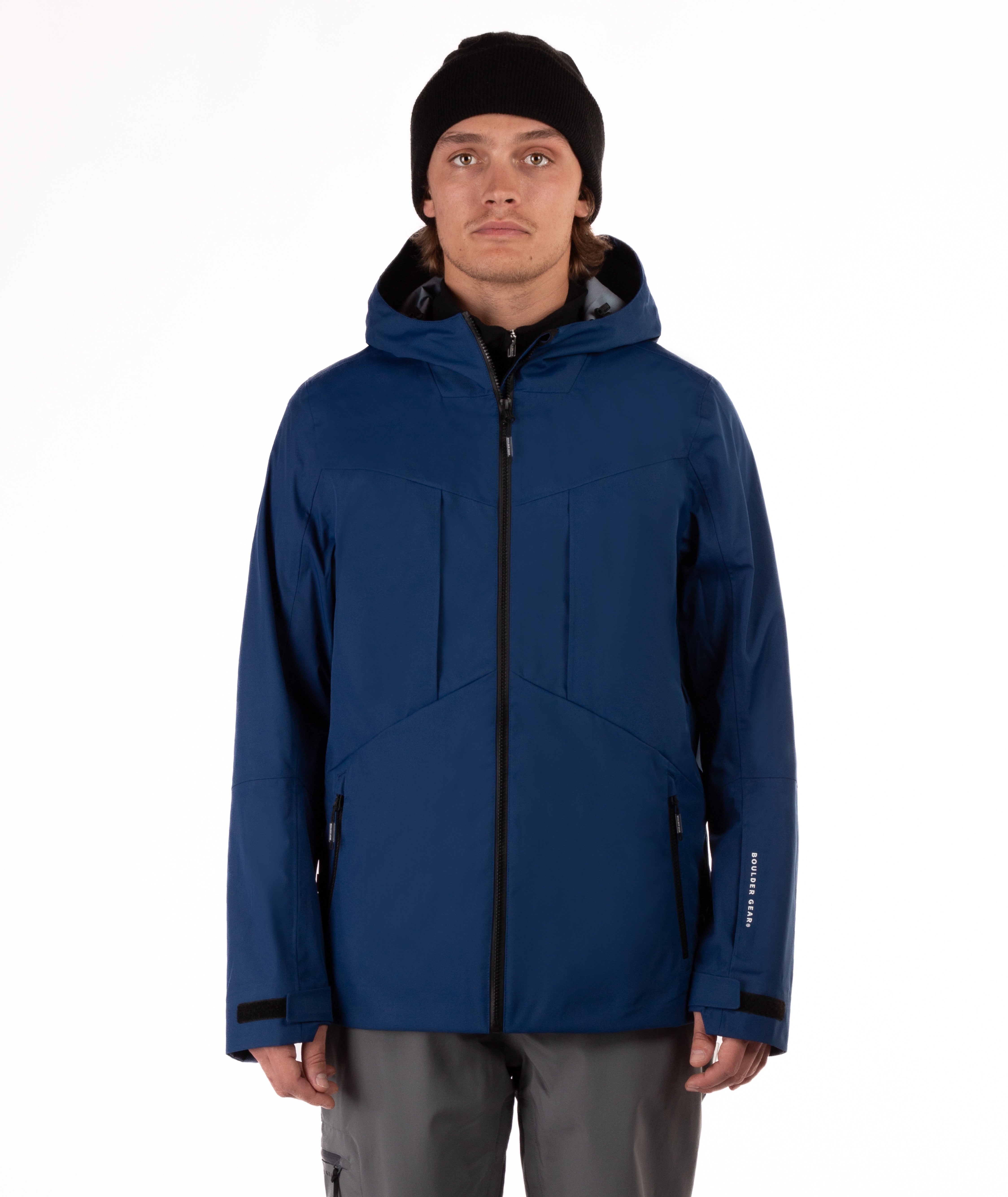 Man wearing a blue jacket with black accents on a white background