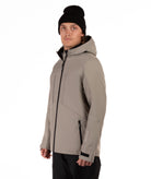 Man wearing a beige jacket with black accents on a white background