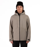 Man wearing a beige jacket with black accents on a white background