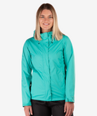 Woman wearing a turquoise jacket on a white background