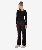 Person wearing a black rain pants on a white background