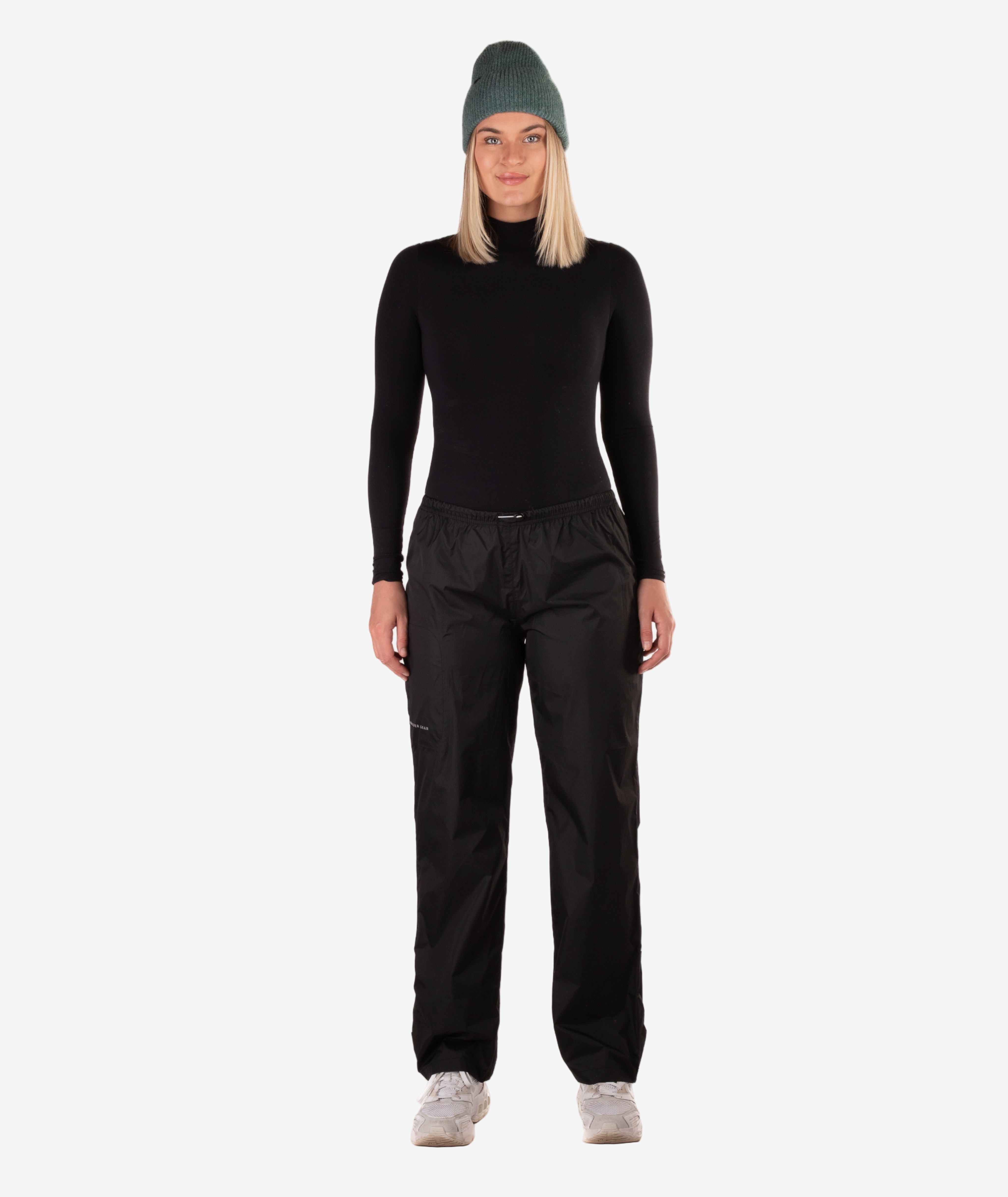 Person wearing a black rain pants on a white background