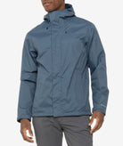 Person wearing a blue rain jacket on a white background