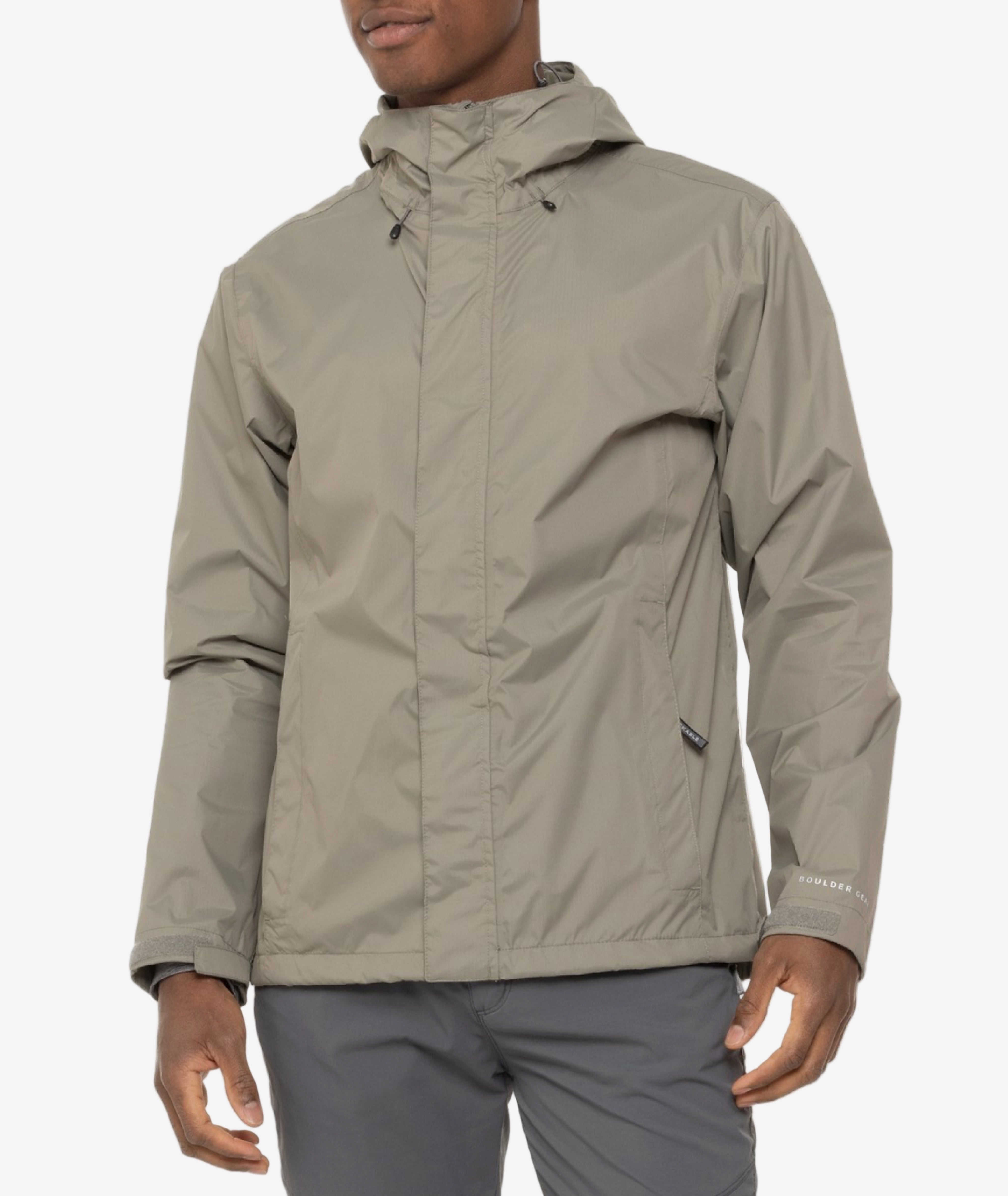 Person wearing a beige rain jacket on a white background
