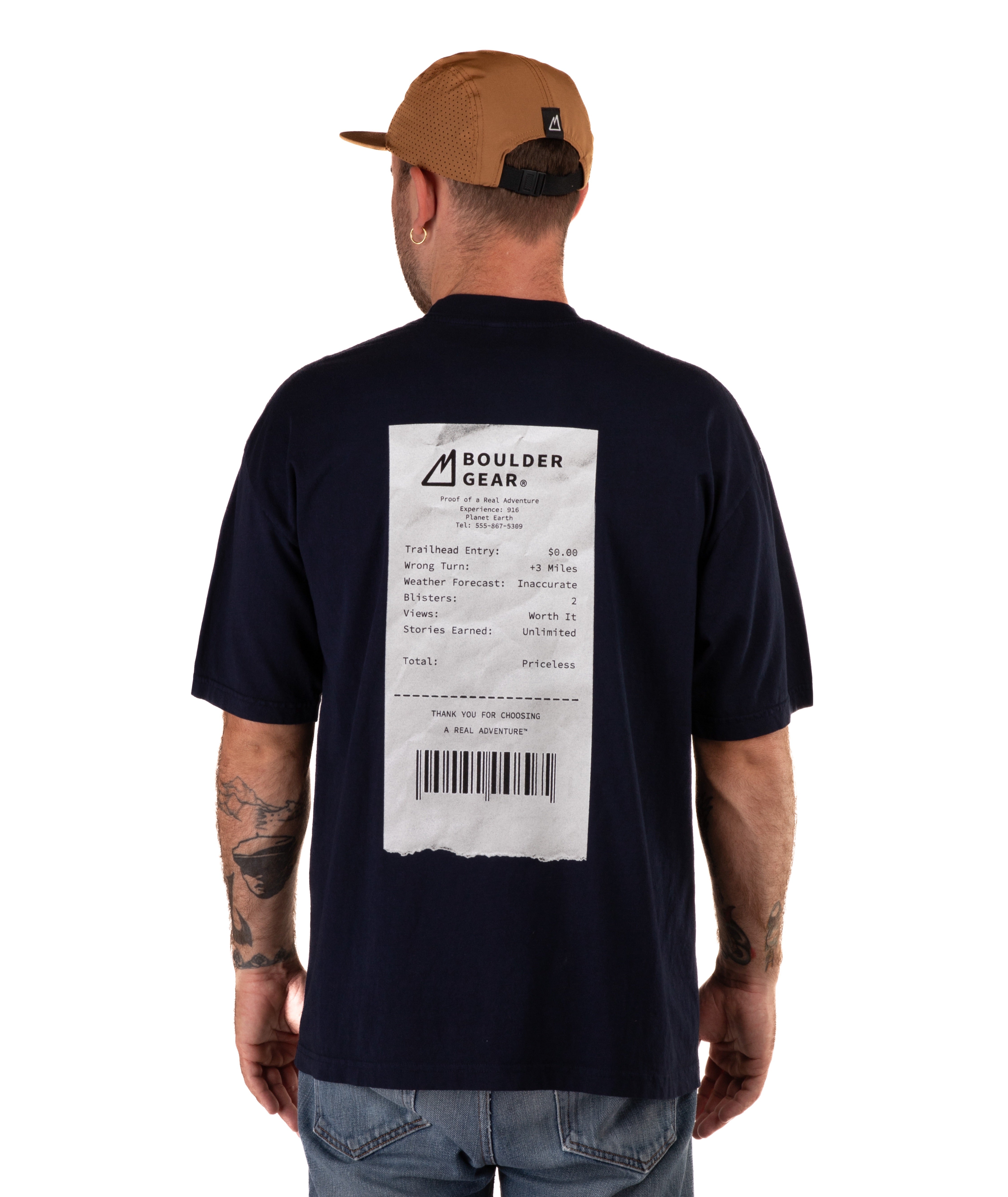 back of Man wearing a navy t-shirt with a receipt graphic and a brown cap on a white background