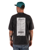 back of Man wearing a faded black t-shirt with a receipt graphic and a green cap on a white background