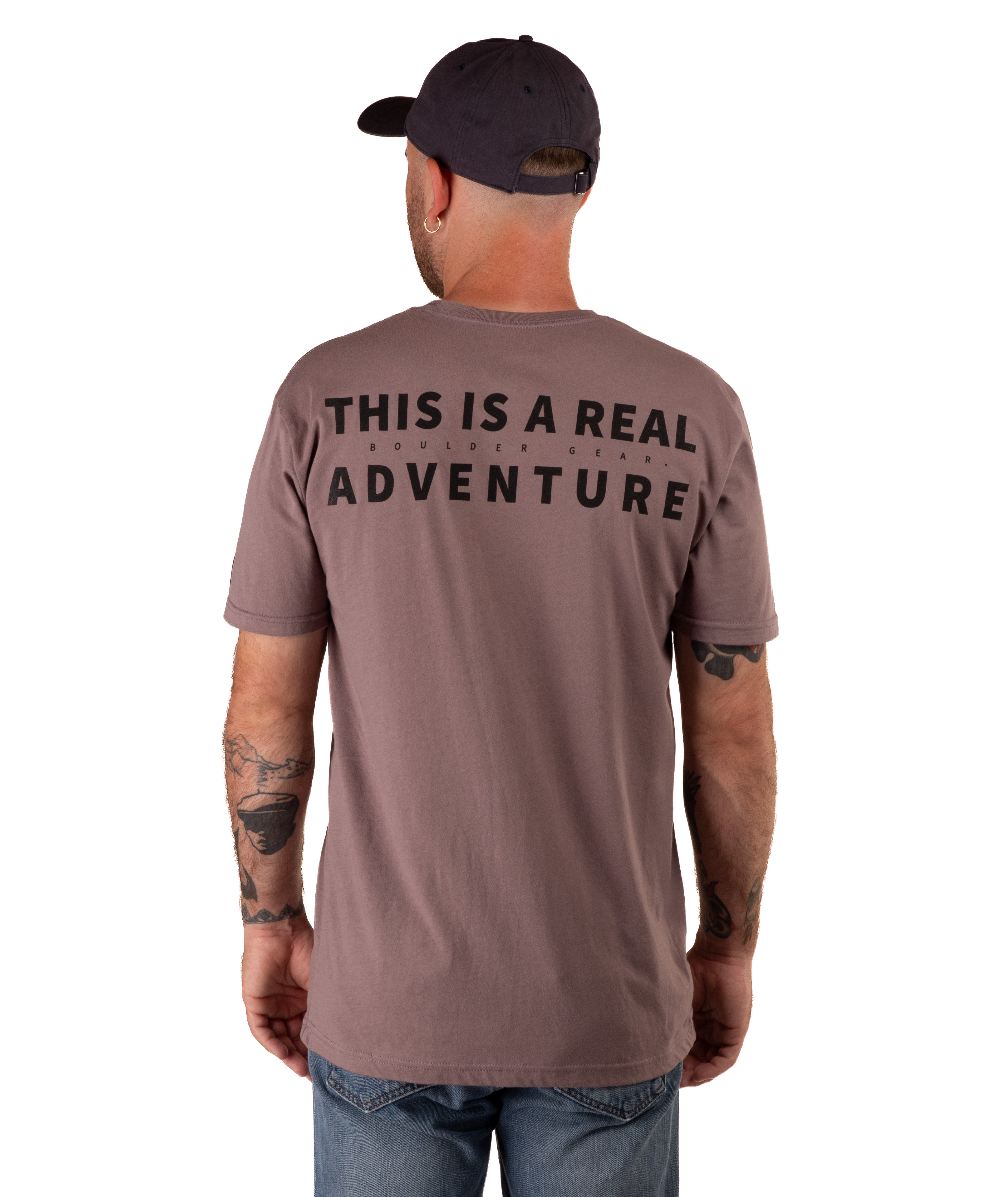 back of a man in a brown shirt with black text and a black hat on a white background