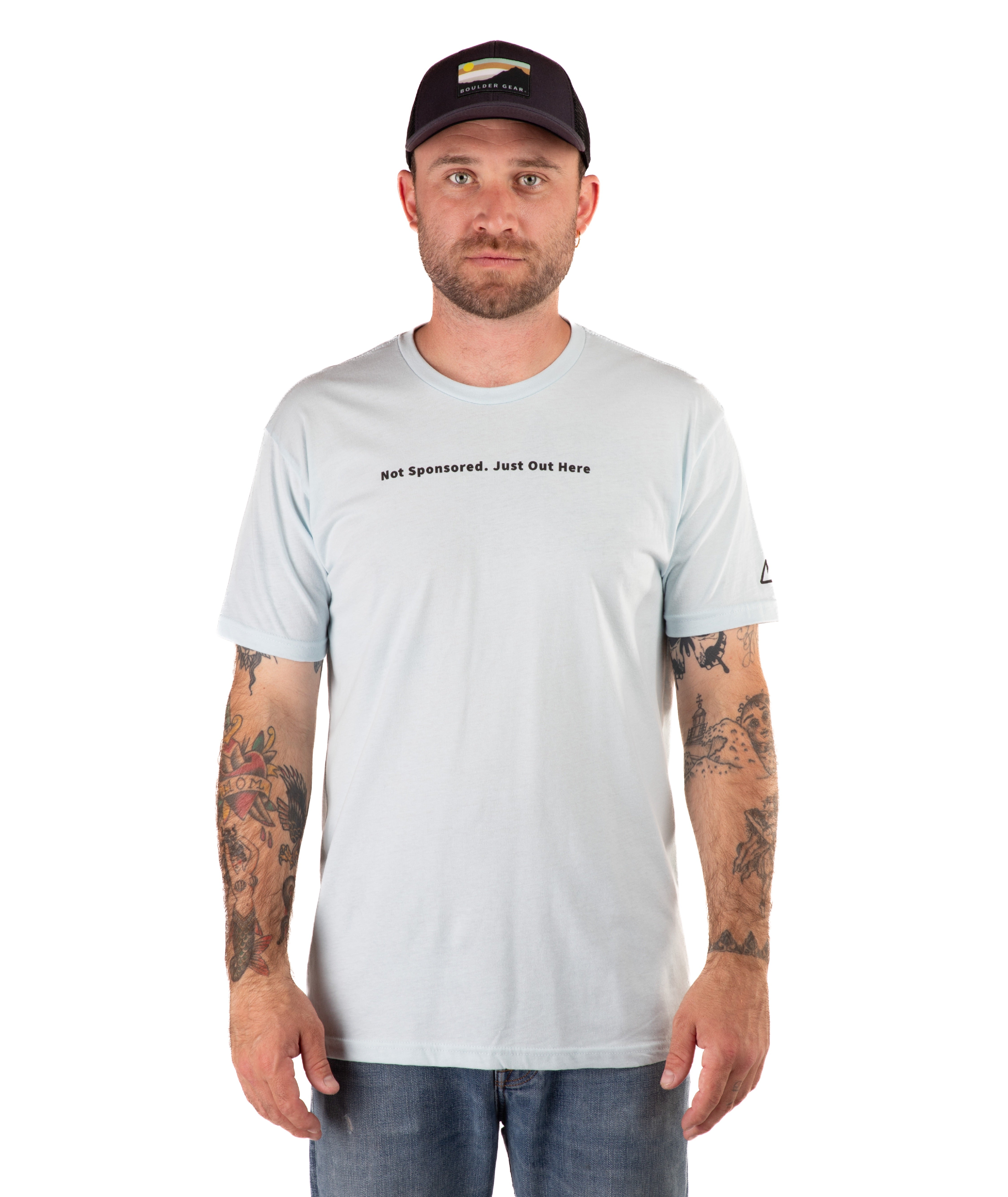 Man wearing a light blue t-shirt with text and a black cap on a white background