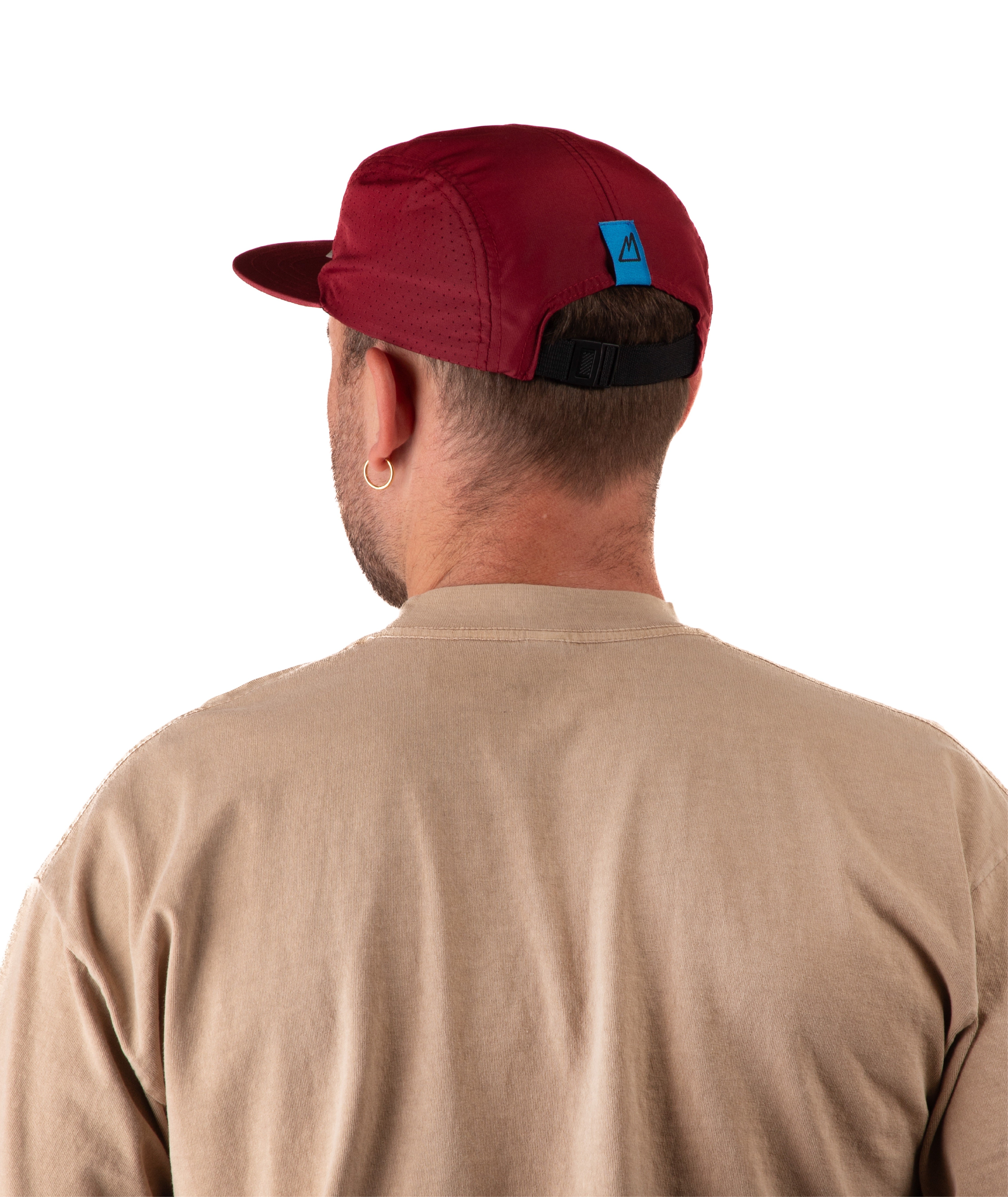 back of  Man wearing a beige t-shirt  and a maroon cap on a white background
