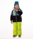 Child wearing a two-tone jacket with a geometric multi-color print on the top and black on the bottom of the jacket