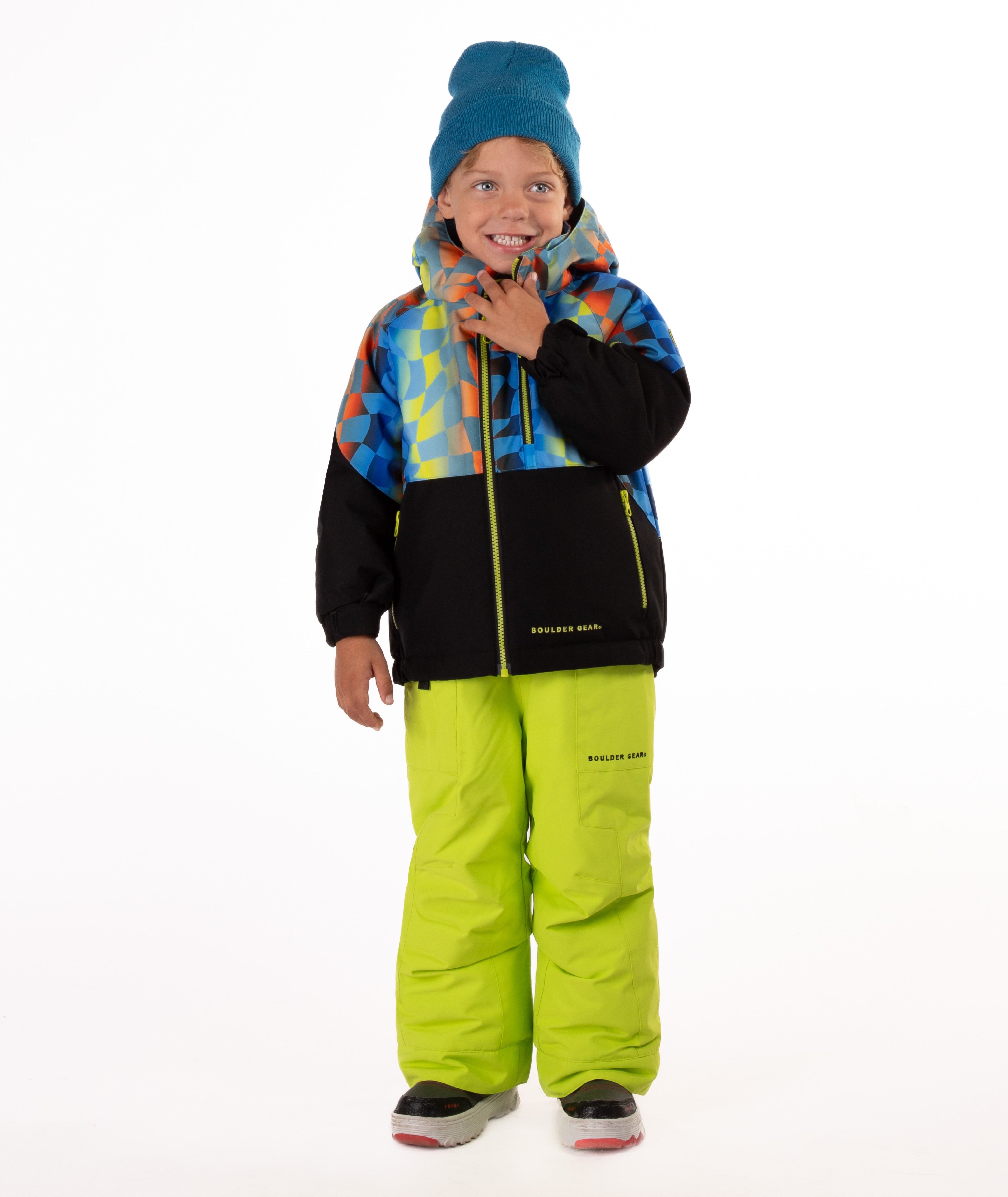 Child wearing a two-tone jacket with a geometric multi-color print on the top and black on the bottom of the jacket