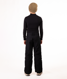 back of youth boy wearing a black long-sleeve shirt and black snow pants on a white background