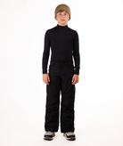 youth boy wearing a black long-sleeve shirt and black snow pants on a white background