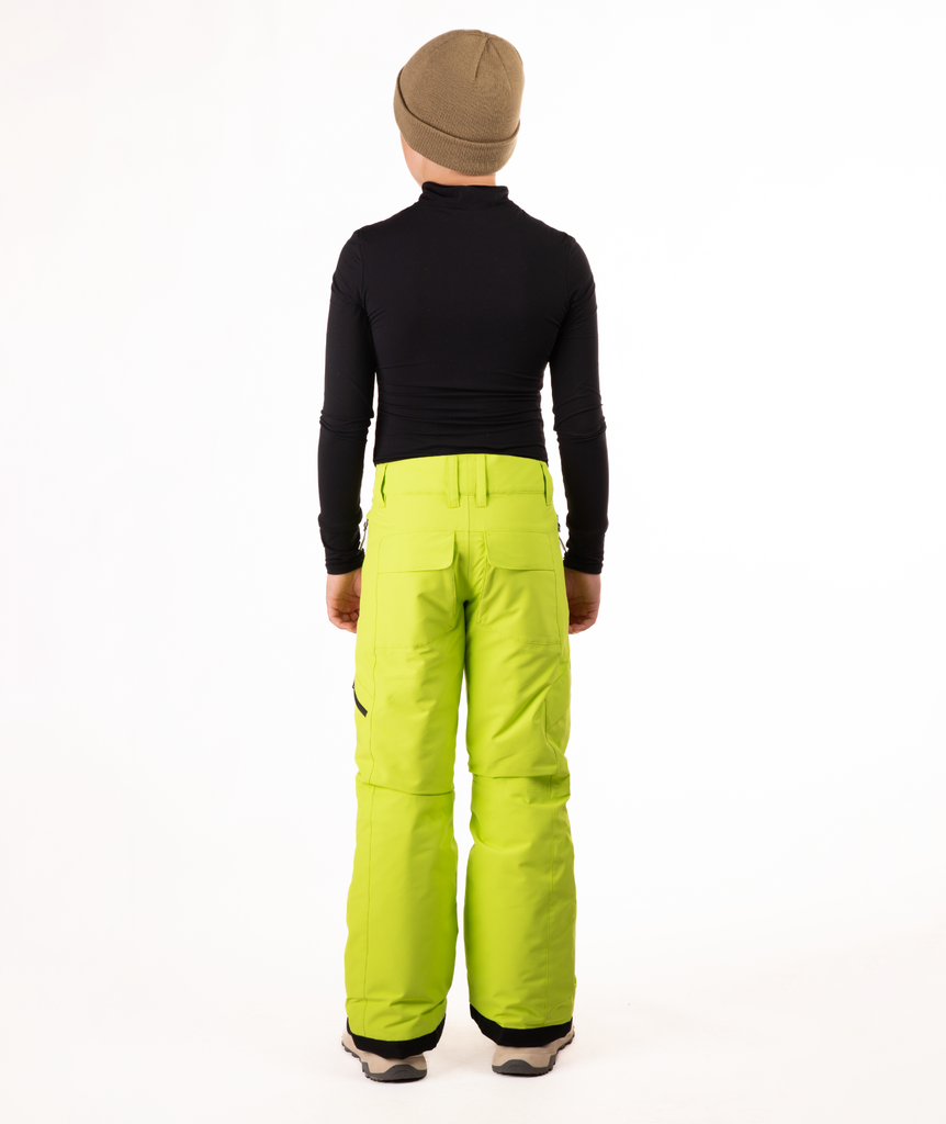 back of youth boy wearing a black long-sleeve shirt and bright green snow pants on a white background