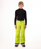 youth boy wearing a black long-sleeve shirt and bright green snow pants on a white background