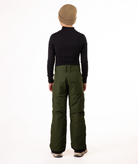 back of youth boy wearing a black long-sleeve shirt and green snow pants on a white background