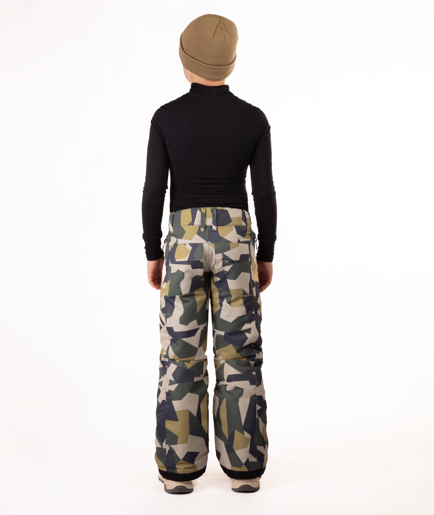 back of youth boy wearing a black long-sleeve shirt and camouflage snow pants on a white background