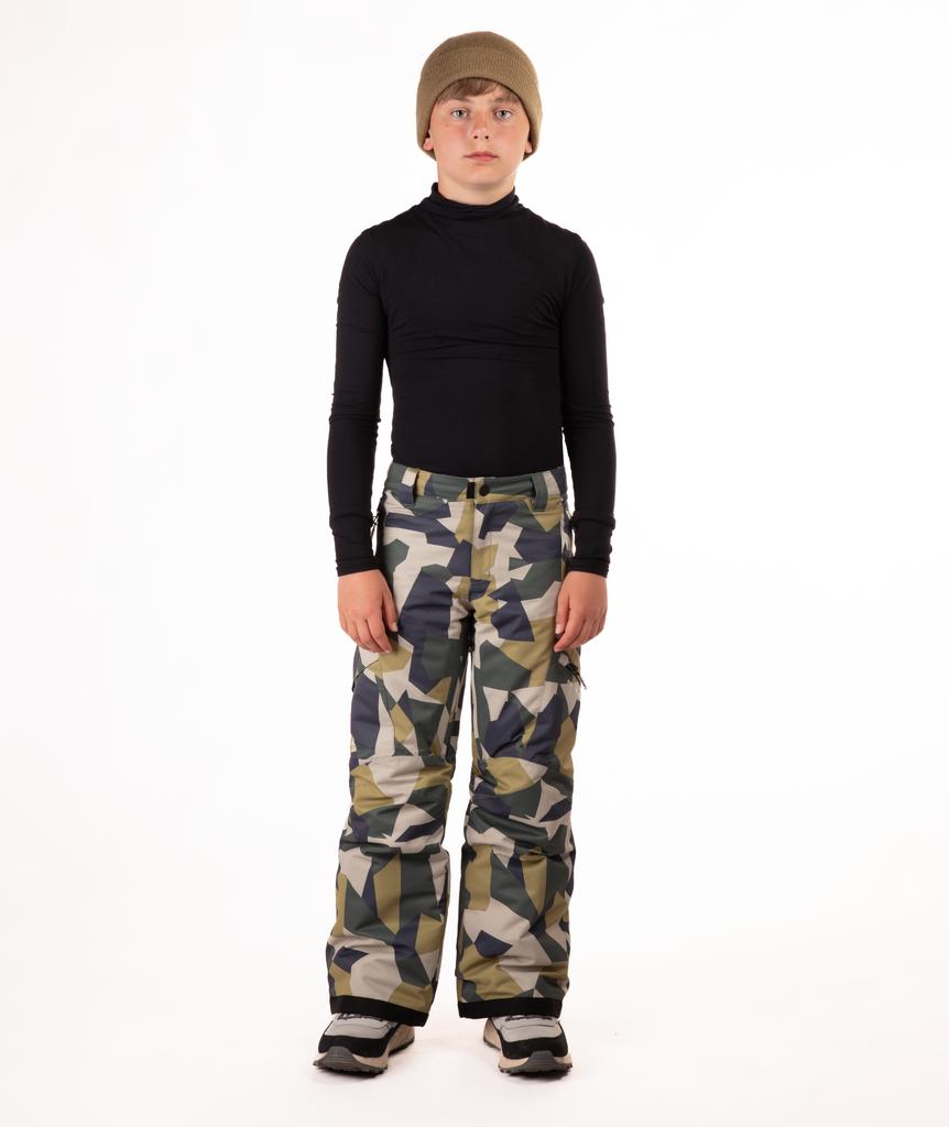 youth boy wearing a black long-sleeve shirt and camouflage snow pants on a white background