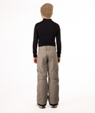 back of youth boy wearing a black long-sleeve shirt and beige snow pants on a white background