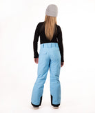 A person shown from the back wearing light blue ski pants, a black long-sleeve top, and a gray beanie against a plain white studio background.