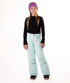 girl wearing light blue snow pants and a black long-sleeve top on a white background