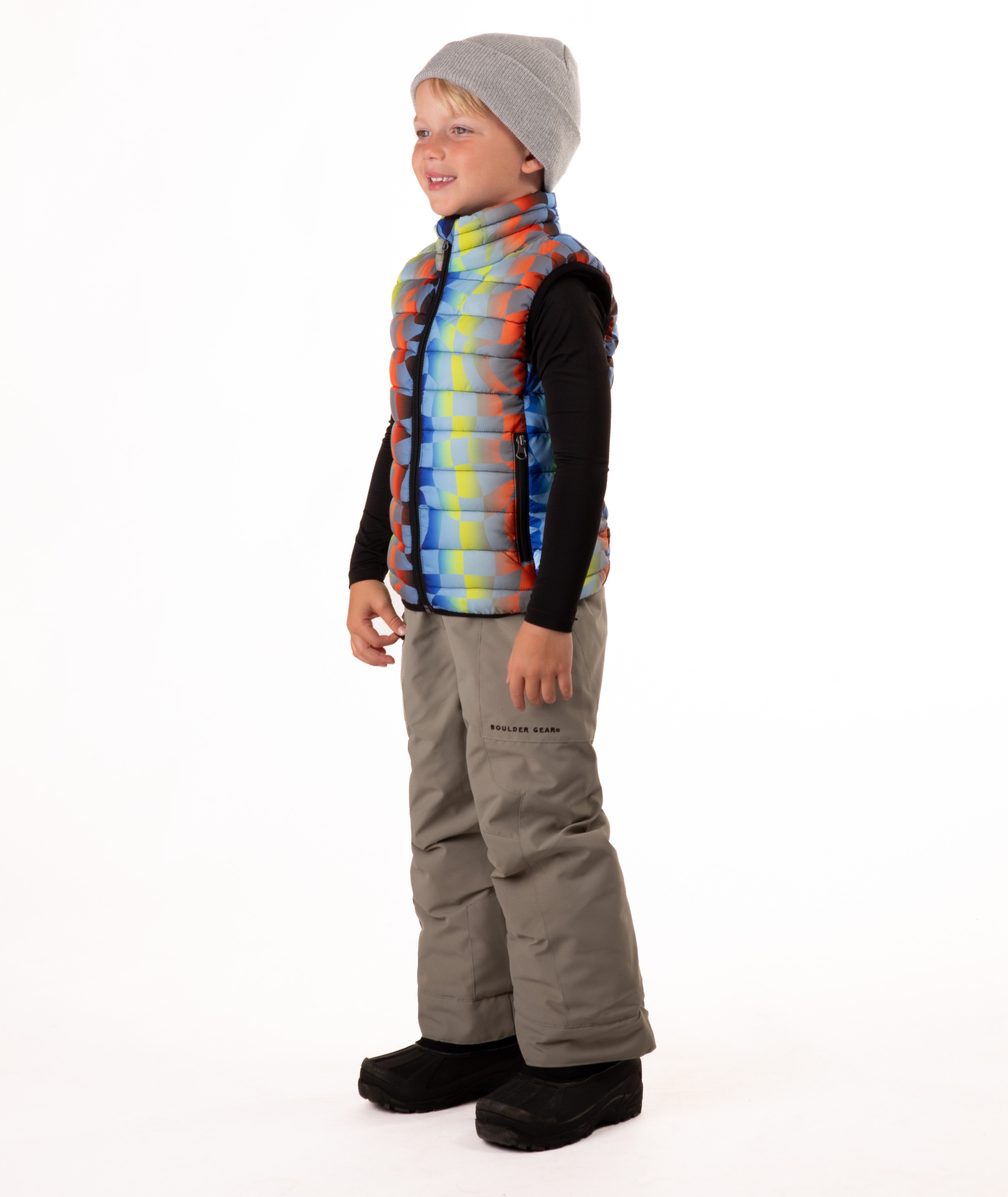 Child wearing a colorful checker patterned puffer vest on a white background