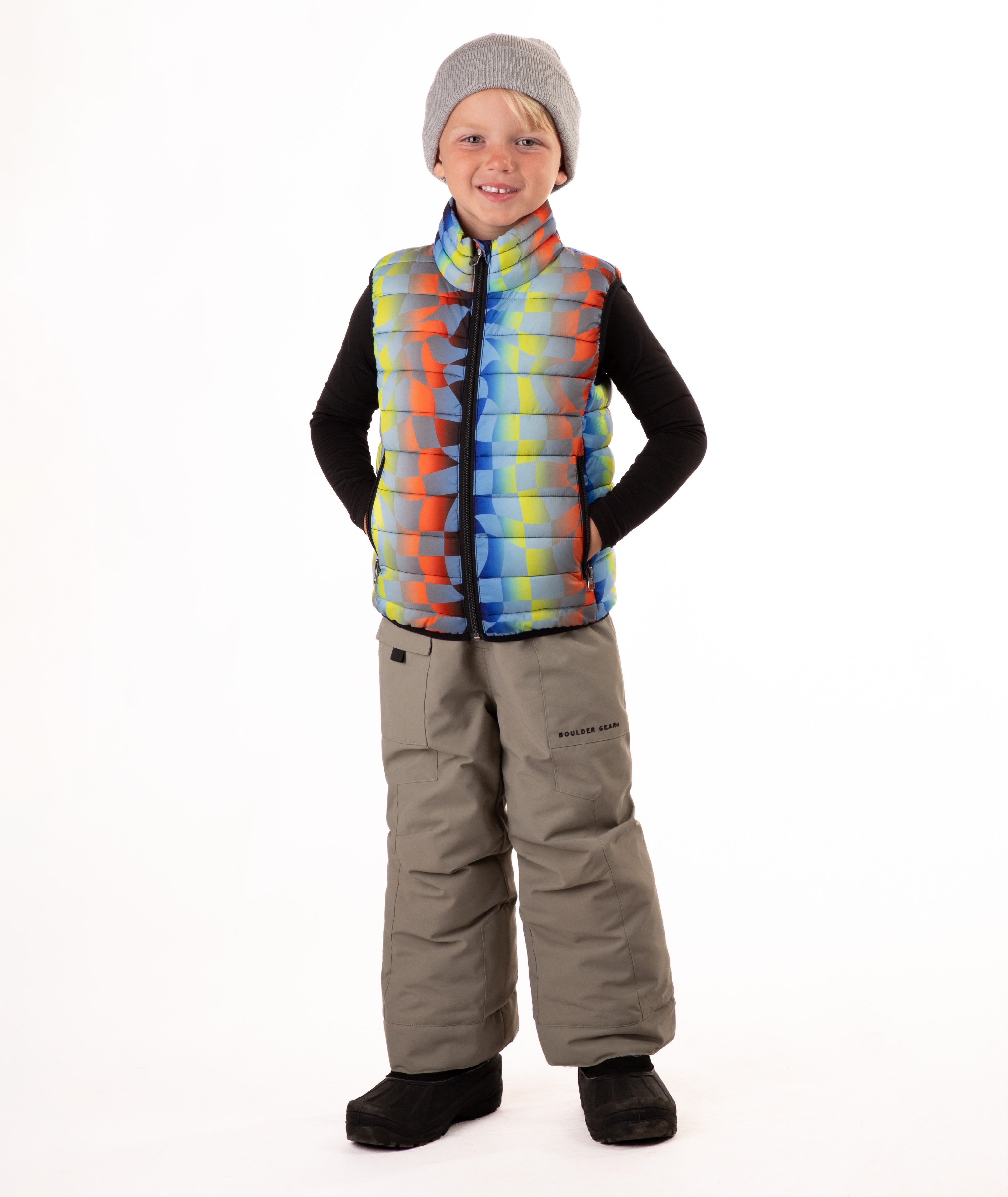Child wearing a colorful checker patterned puffer vest on a white background