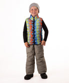 Child wearing a colorful checker patterned puffer vest on a white background