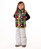 Child wearing multi colored flower print vest with yellow accents on a white background