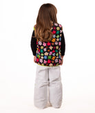 back of Child wearing multi colored flower print vest with yellow accents on a white background