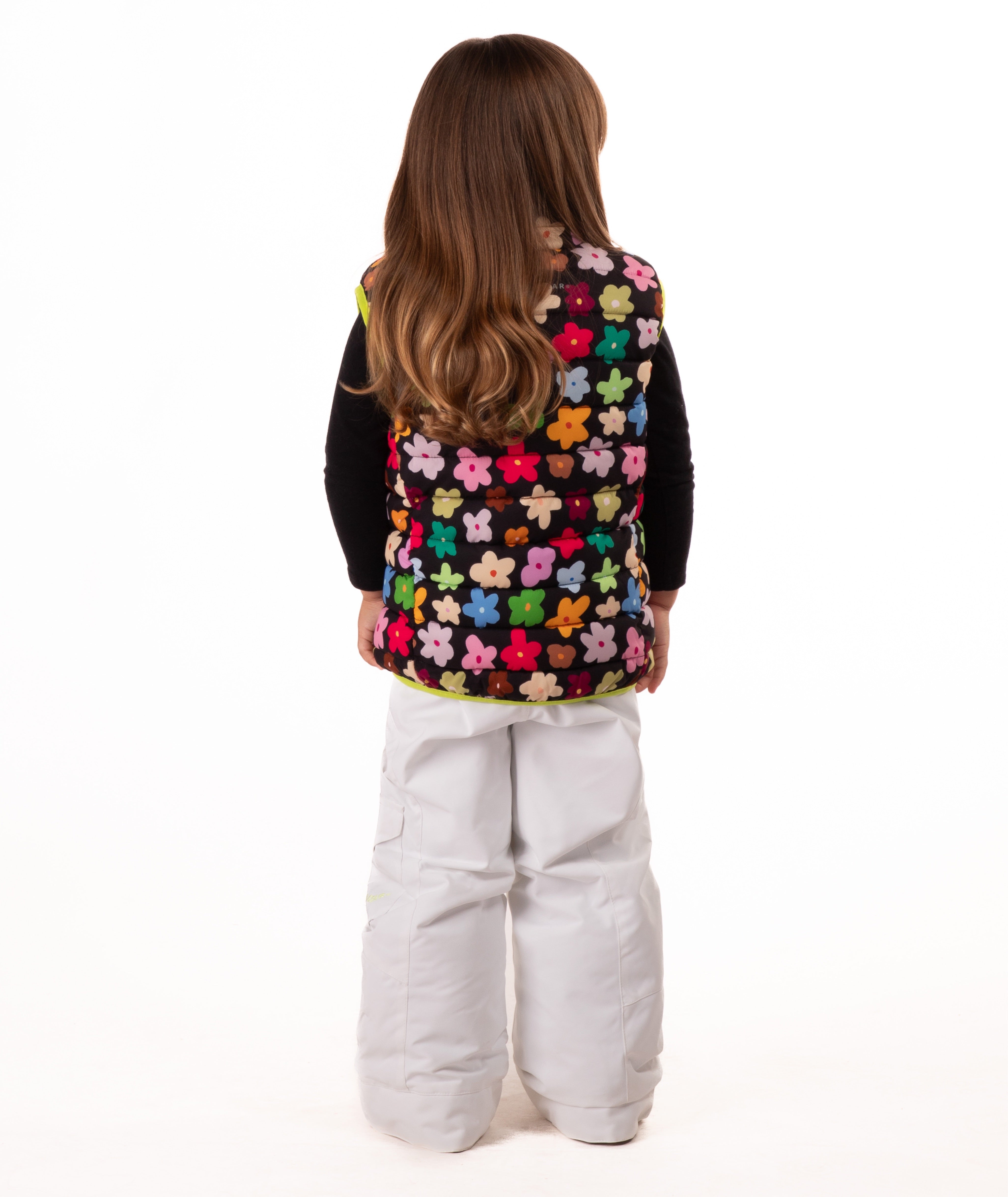 back of Child wearing multi colored flower print vest with yellow accents on a white background