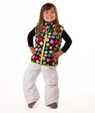Child wearing multi colored flower print vest with yellow accents on a white background
